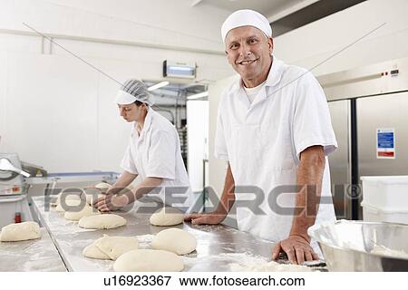 Stock Photo - Chefs baking in kitchen. Fotosearch