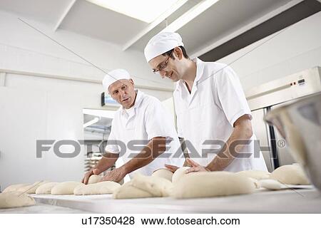 Stock Photo - Chefs baking in kitchen. Fotosearch