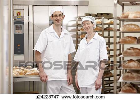 Chefs smiling together in kitchen View Large Photo Image Stock Photo - Chefs smiling together in kitchen. Fotosearch
