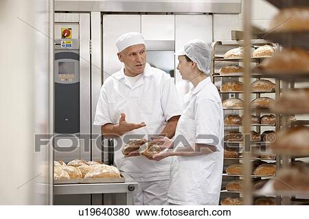 Chefs talking at oven in kitchen View Large Photo Image Stock Image - Chefs talking at oven in kitchen. Fotosearch