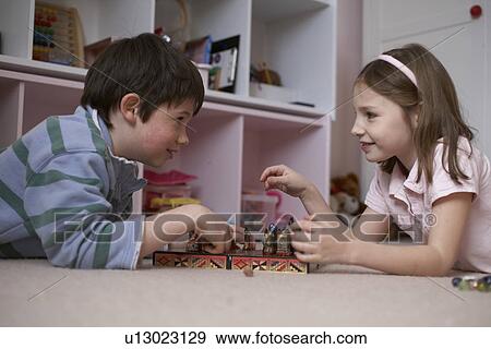 Stock Photo - Children playing chess in bedroom. Fotosearch