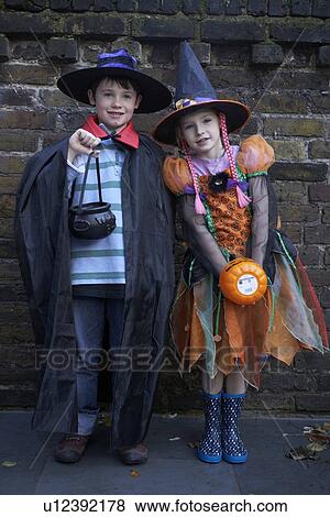 Stock Photo - Children wearing Halloween costumes. Fotosearch