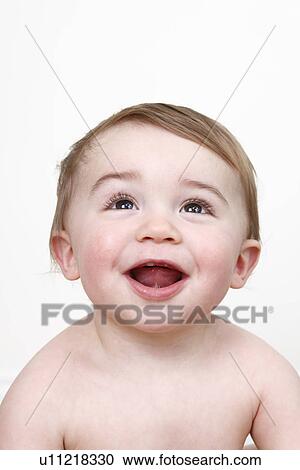 Stock Image - Close up of baby boys smiling face. Fotosearch