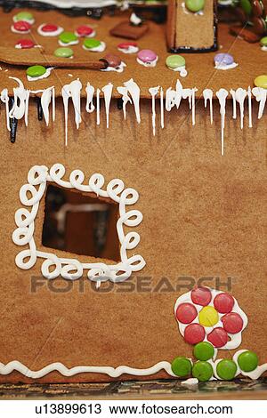 Stock Image - Close up of decorated gingerbread house. Fotosearch