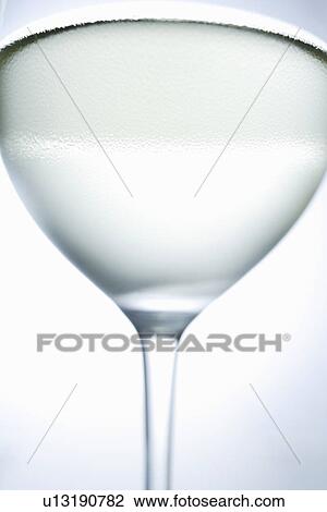 Stock Image - Close up of glass of white wine. Fotosearch
