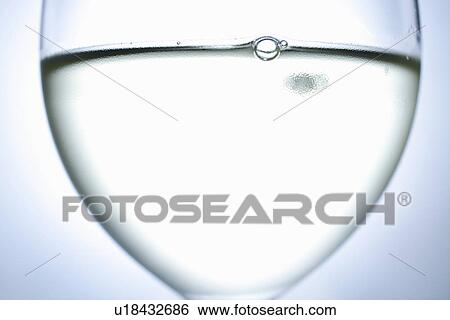 Stock Photograph - Close up of glass of white wine. Fotosearch
