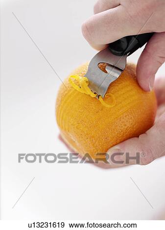 Close up of hands zesting orange View Large Photo Image Stock Photo - Close up of hands zesting orange. Fotosearch