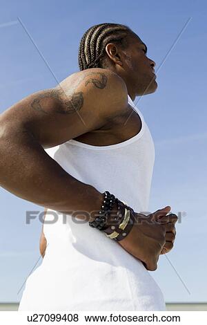 Stock Photo - Close up of man running outdoors. Fotosearch