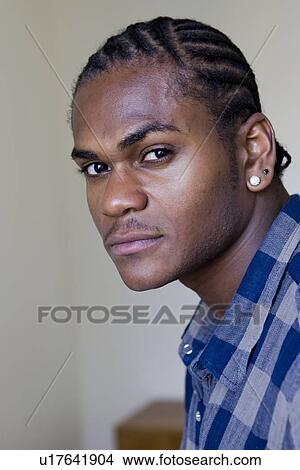 Picture - Close up of mans serious face. Fotosearch
