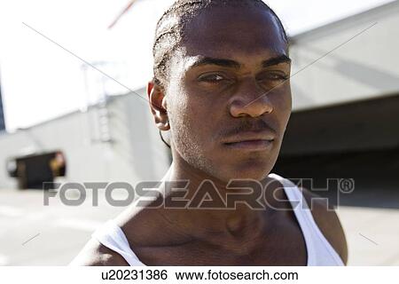 Stock Photograph - Close up of mans serious face. Fotosearch