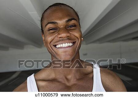 Stock Photo - Close up of mans smiling face. Fotosearch