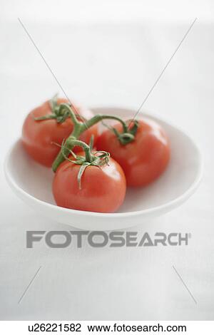 Stock Image - Close up of plate of tomatoes. Fotosearch