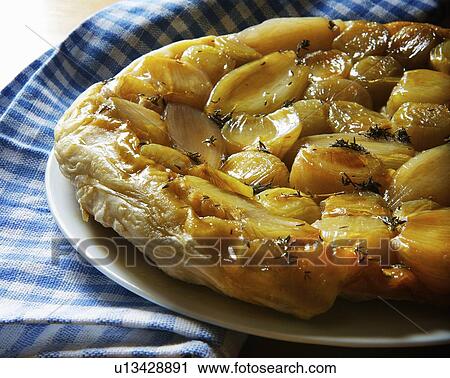 Stock Image - Close up of shallot tart. Fotosearch