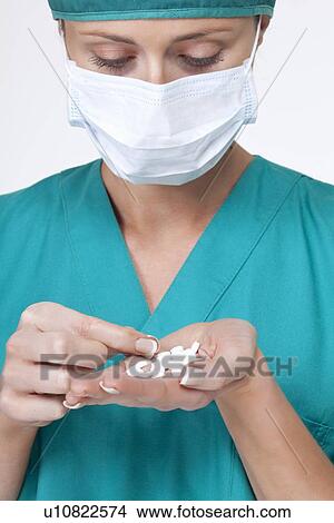 Close up of surgeon counting pills View Large Photo Image Picture - Close up of surgeon counting pills. Fotosearch