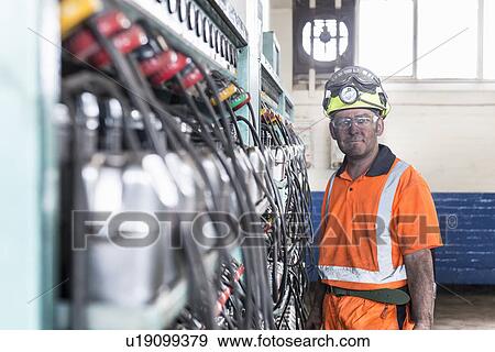 Coal miner standing at control panel View Large Photo Image Stock Photo - Coal miner standing at control panel. Fotosearch