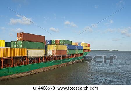 Stock Photo - Container ship sailing into harbor. Fotosearch