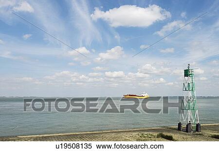 Stock Photography - Container ship sailing into harbor. Fotosearch