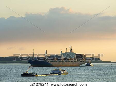 Container ship sailing on river View Large Photo Image Stock Image - Container ship sailing on river. Fotosearch