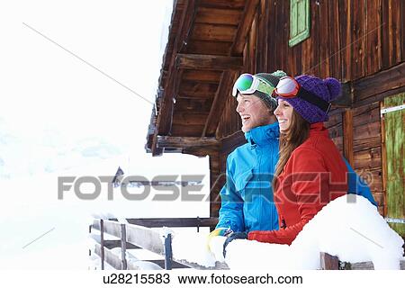 Stock Image - Couple overlooking snowy landscape. Fotosearch