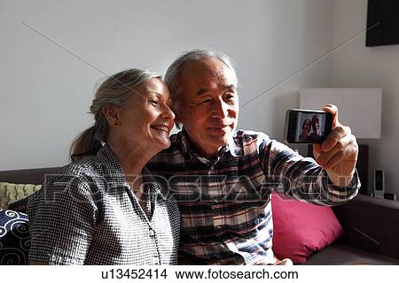 Couple taking pictures of themselves View Large Photo Image Picture - Couple taking pictures of themselves. Fotosearch