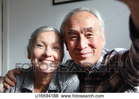 Couple taking pictures of themselves View Large Photo Image Stock Photo - Couple taking pictures of themselves. Fotosearch
