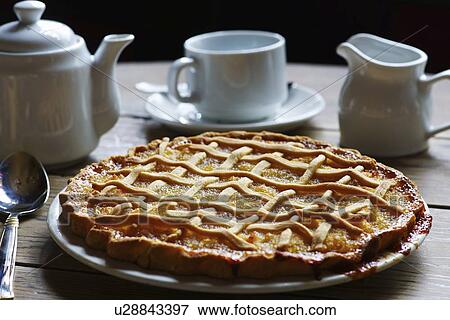 Stock Photo - Dish of treacle tart with coffee. Fotosearch