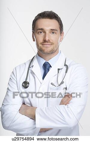 Picture - Doctor standing with crossed arms. Fotosearch