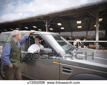 Stock Photograph - Farmer talking to veterinarian in car. Fotosearch
