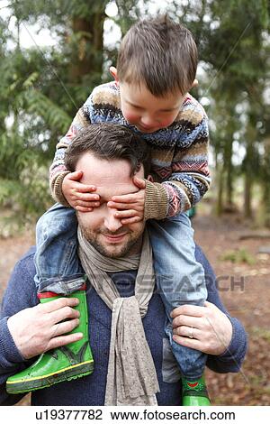 Father carrying son on shoulders View Large Photo Image Stock Image - Father carrying son on shoulders. Fotosearch