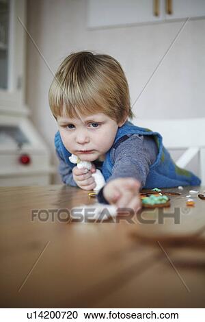 Girl decorating gingerbread cookies View Large Photo Image Stock Image - Girl decorating gingerbread cookies. Fotosearch
