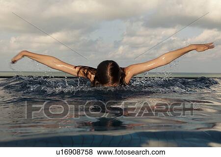 Girl swimming in infinity pool View Large Photo Image Stock Photo - Girl swimming in infinity pool. Fotosearch