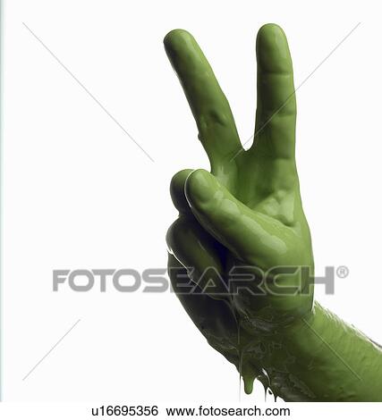 Green painted hand making peace sign View Large Photo Image Stock Photograph - Green painted hand making peace sign. Fotosearch