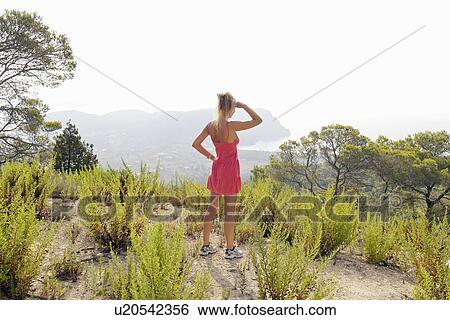 Hiker overlooking hilltop landscape View Large Photo Image Stock Photograph - Hiker overlooking hilltop landscape. Fotosearch
