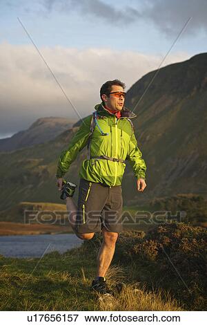 Hiker stretching in rural landscape View Large Photo Image Stock Photo - Hiker stretching in rural landscape. Fotosearch