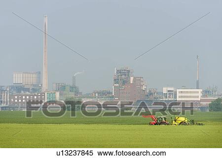 Stock Photography - Industrial buildings by fields. Fotosearch