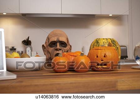 Jack-o-lanterns and mask in kitchen View Large Photo Image Stock Photograph - Jack-o-lanterns and mask in kitchen. Fotosearch
