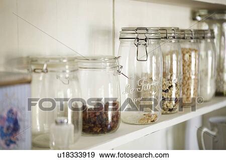Stock Photo - Jars of dried foods on shelf. Fotosearch