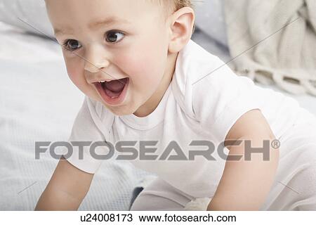 Laughing baby crawling on couch View Large Photo Image Stock Image - Laughing baby crawling on couch. Fotosearch