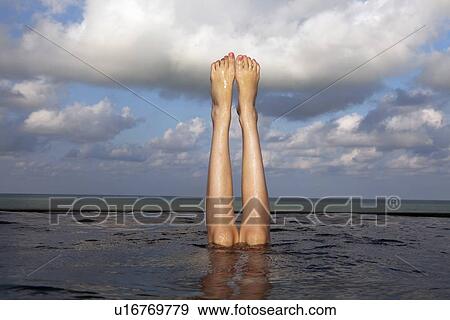 Legs sticking out of infinity pool View Large Photo Image Stock Photo - Legs sticking out of infinity pool. Fotosearch