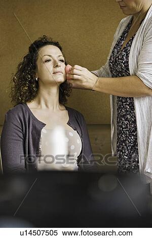 Stock Photography - Make up artist working on client. Fotosearch
