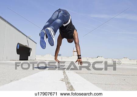 Man jumping on rooftop View Large Photo Image Stock Image - Man jumping on rooftop. Fotosearch