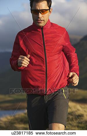 Man running on rural mountain road View Large Photo Image Stock Photography - Man running on rural mountain road. Fotosearch