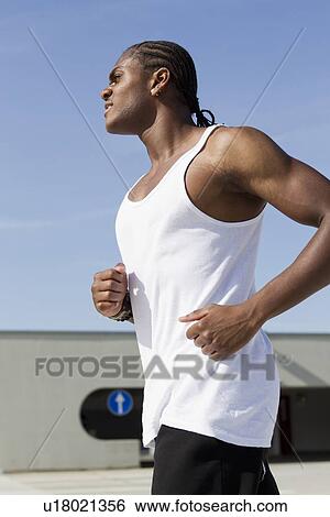 Man running on urban street View Large Photo Image Stock Photograph - Man running on urban street. Fotosearch