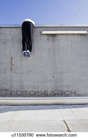 Man scaling wall on city street View Large Photo Image Stock Image - Man scaling wall on city street. Fotosearch