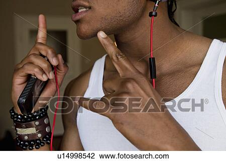Stock Image - Man singing with headphones. Fotosearch