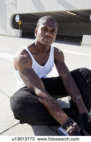 Man sitting on concrete sidewalk View Large Photo Image Stock Image - Man sitting on concrete sidewalk. Fotosearch