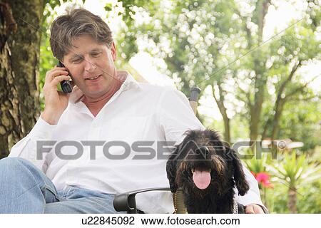 Man talking on phone outdoors View Large Photo Image Stock Image - Man talking on phone outdoors. Fotosearch