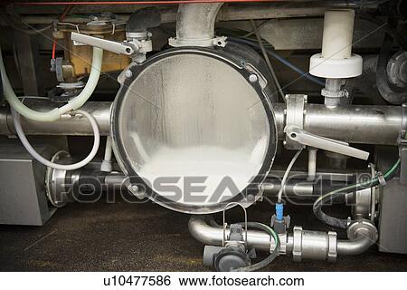 Stock Photograph - Milk in collection machinery in parlor. Fotosearch