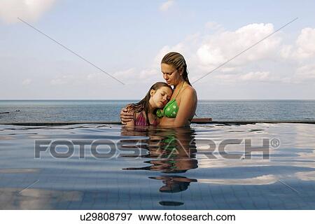Mother and daughter in infinity pool View Large Photo Image Stock Photo - Mother and daughter in infinity pool. Fotosearch