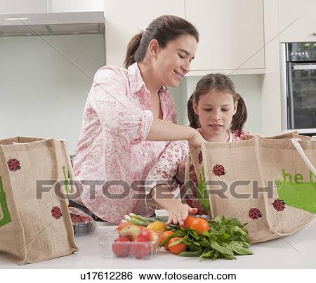 Mother and daughter unloading groceries View Large Photo Image Stock Photograph - Mother and daughter unloading groceries. Fotosearch